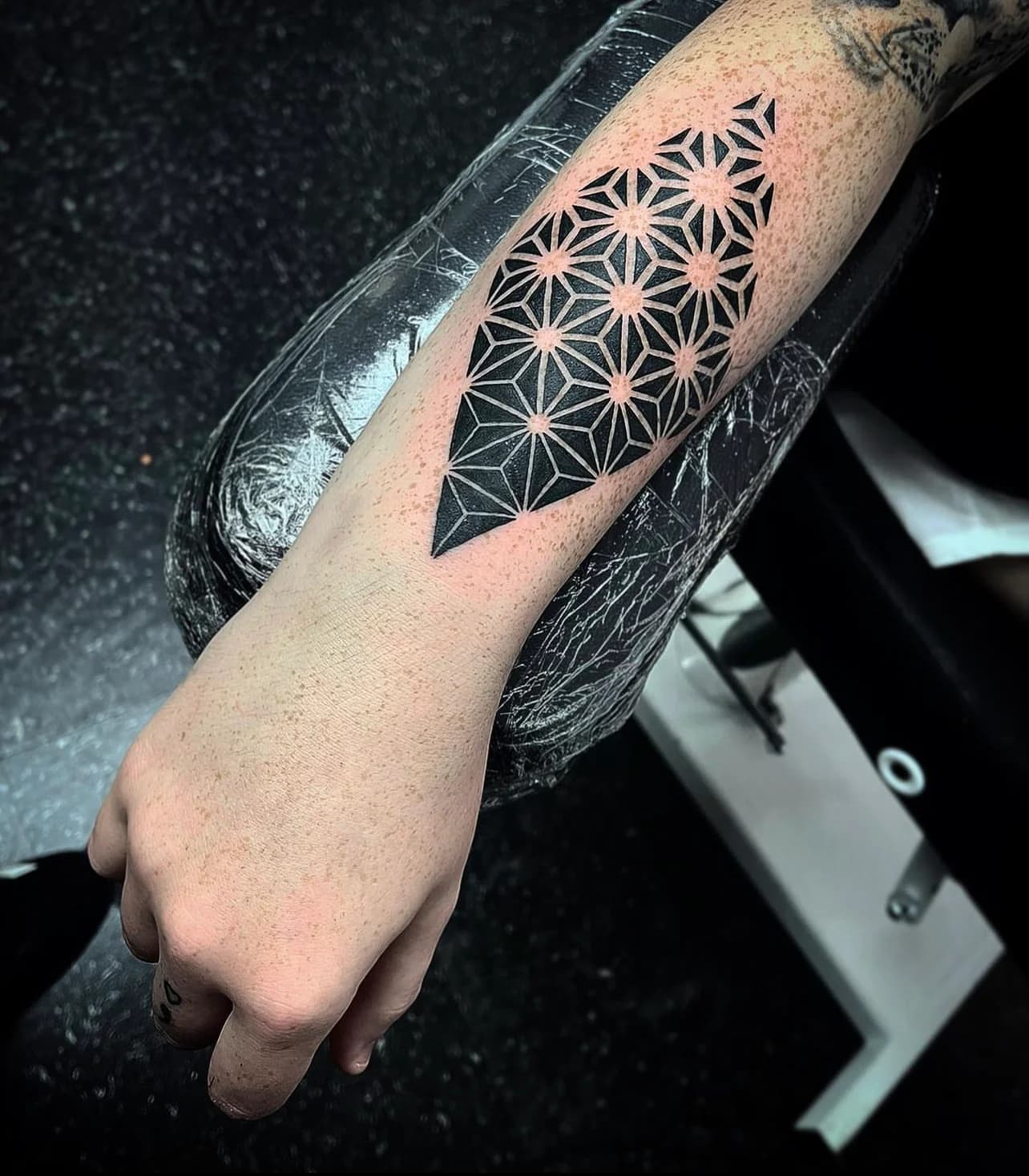 Geometric patterned tattoo on forearm.