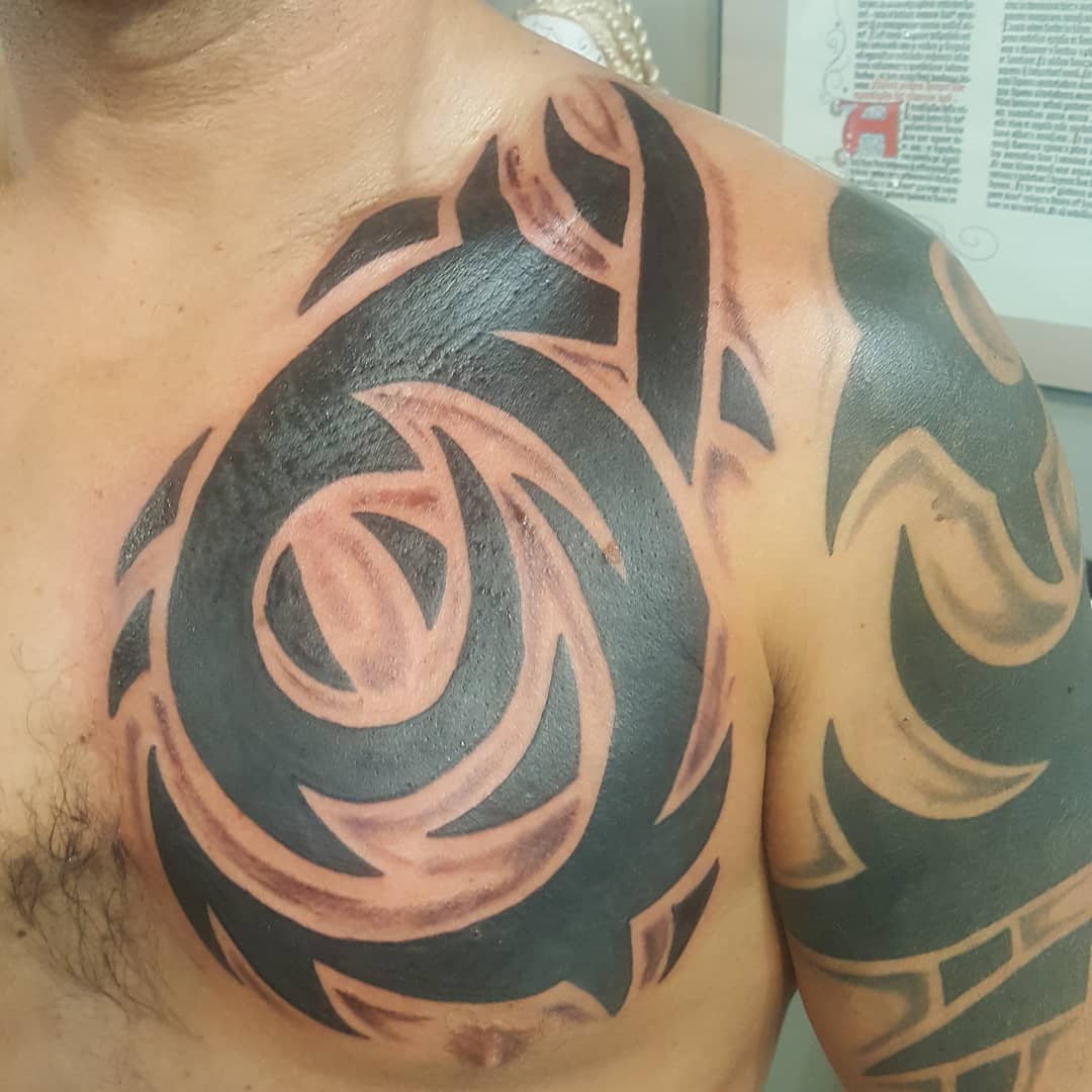 Tribal-style shoulder and chest tattoo design